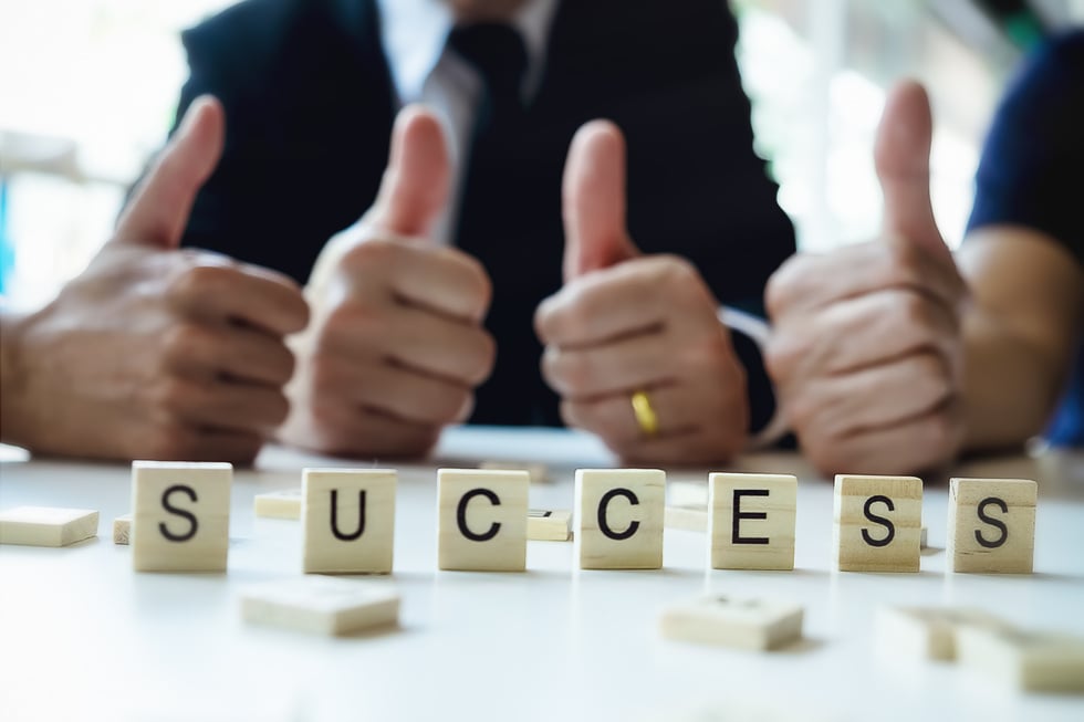 Success Word on Business Working Table. Wooden Cross Word